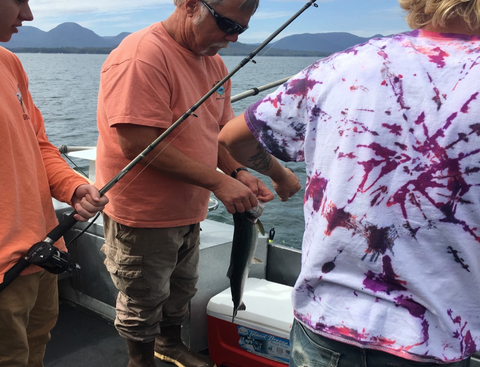 Unhooking Salmon In Alaska
